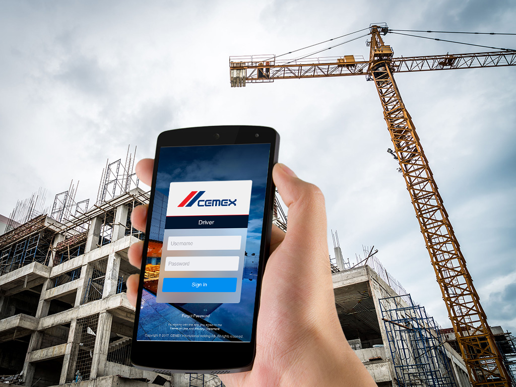 Person holding mobile phone with Cemex app on the screen